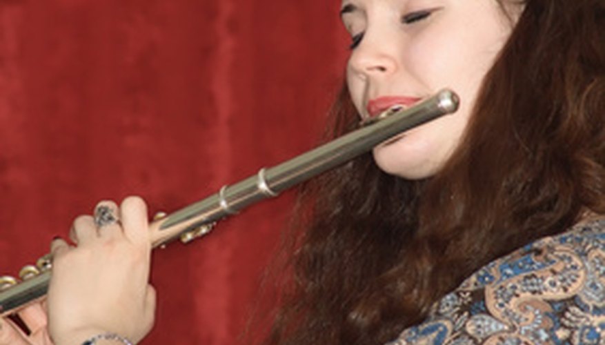 The side blown flute is typically held as shown. Note the position of the player's lips--blowing across, not into, the blow hole. The side blown flute is typically held as shown. Note the position of the player's lips--blowing across, not into, the blow hole.