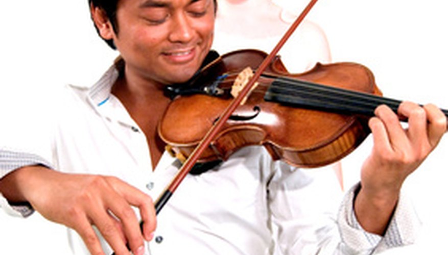 Photo Credit: man playing violin image by Ramona smiers from <a href='http://www.fotolia.com'>Fotolia.com</a> The tender violin has been known to lend its sound to pop songs.