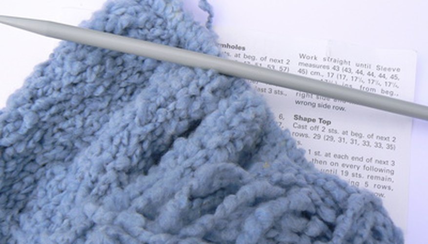 Photo Credit: knitting image by Alison Bowden from <a href='http://www.fotolia.com'>Fotolia.com</a> A knitting machine can help reduce the time needed to knit large items.