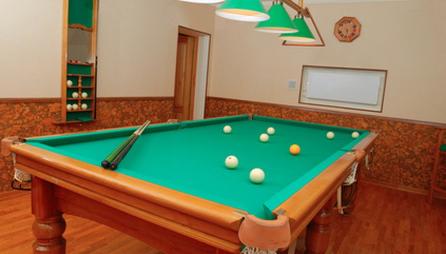 Photo Credit: Billiards room interior image by Nikolay Okhitin from <a href='http://www.fotolia.com'>Fotolia.com</a> Balance your table and cover for extra protection