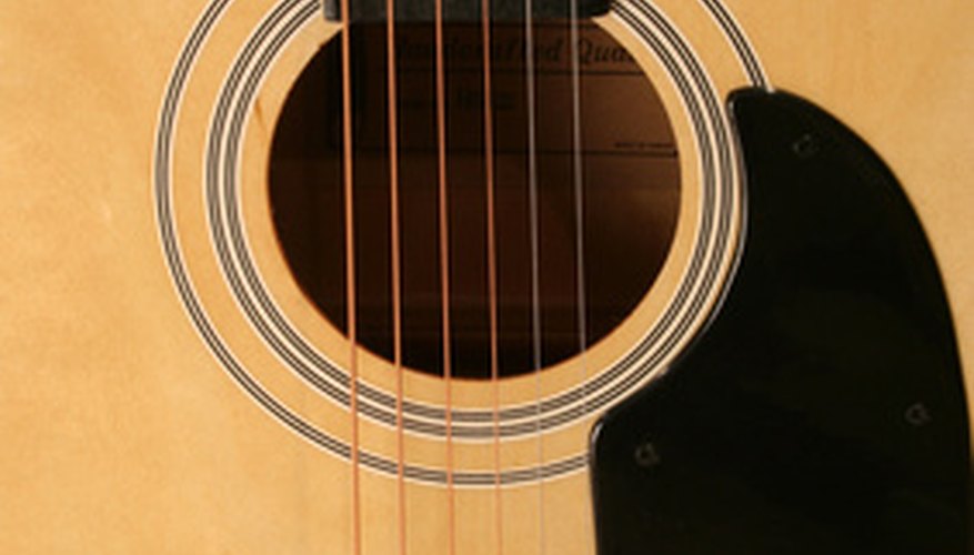 Photo Credit: acoustic guitar image by Jim Mills from <a href='http://www.fotolia.com'>Fotolia.com</a> Convert this to a resonator guitar? It can be done.