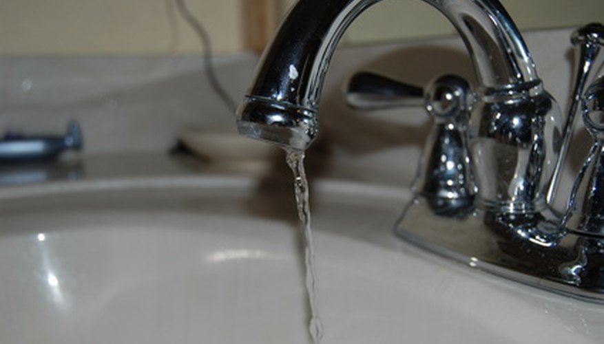 Photo Credit: faucet image by Lynne Davis from <a href='http://www.fotolia.com'>Fotolia.com</a> Rinse the engraved portion of the metal with fresh, cool water.