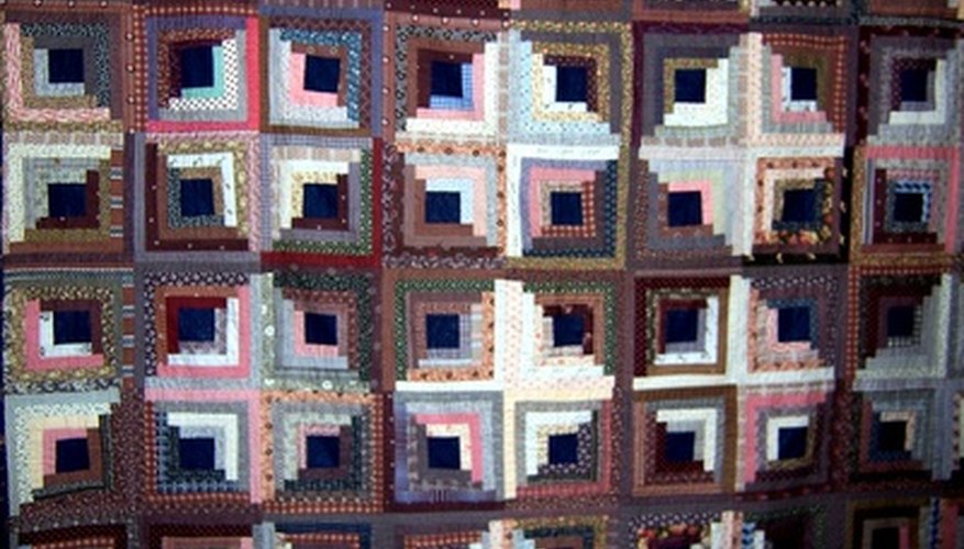 Photo Credit: Patchwork as a background 2 image by Lucy Cherniak from <a href='http://www.fotolia.com'>Fotolia.com</a> Traditional patchwork quilt patterns were prized for using up fabric scraps
