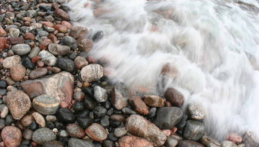 Photo Credit: water motion flowing lake superior rocks agate col image by Paul Retherford from <a href='http://www.fotolia.com'>Fotolia.com</a> Agate can be found on the shoreline when new rocks wash up on the beach.