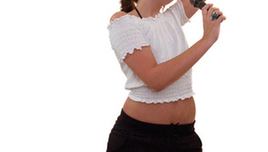Photo Credit: girl singing image by Peter Baxter from <a href='http://www.fotolia.com'>Fotolia.com</a> The singer is often the central figure in pop music.