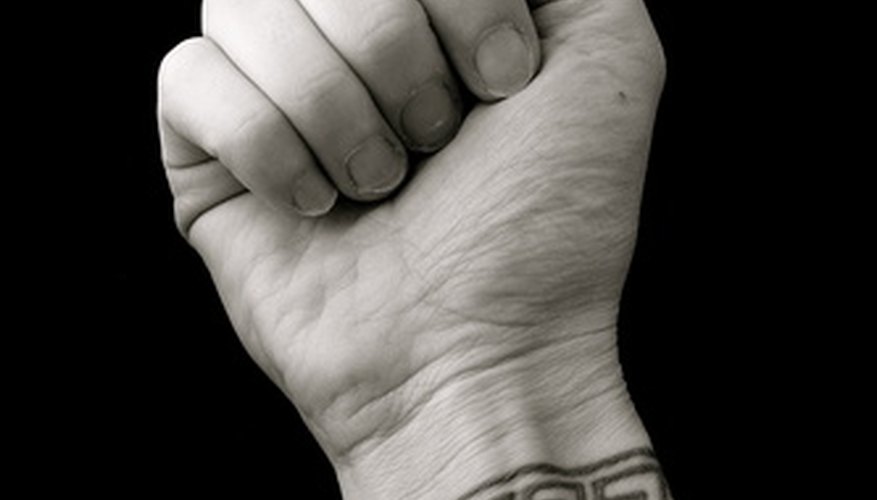 Photo Credit: fist over wrist tattoo of greek key pattern image by nextrecord from <a href='http://www.fotolia.com'>Fotolia.com</a> Measure your wrist.