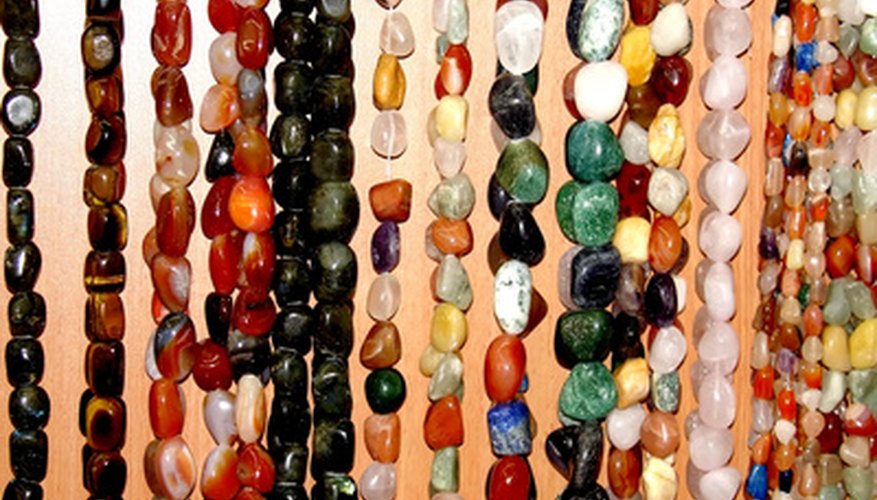 Photo Credit: Assorted strings of gem stones beds image by Asya Babushkina from <a href='http://www.fotolia.com'>Fotolia.com</a> Gemstones can be combined in various ways.