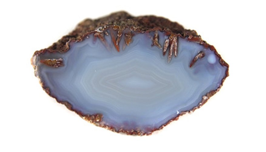 Photo Credit: agate image by jonnysek from <a href='http://www.fotolia.com'>Fotolia.com</a> Agates are heavier than other rocks, have banded patterns and a waxy luster.