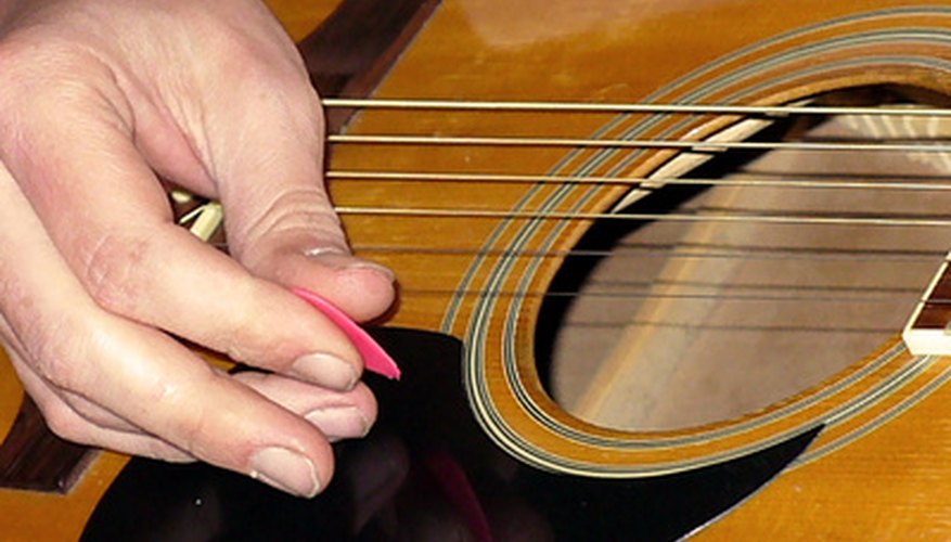 Photo Credit: playing the guitar image by egirldesign from <a href='http://www.fotolia.com'>Fotolia.com</a> The guitar is a popular instrument for beginning musicians.