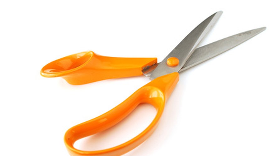 Photo Credit: scissors #3 image by Adam Borkowski from <a href='http://www.fotolia.com'>Fotolia.com</a> Cut off the excess cord.