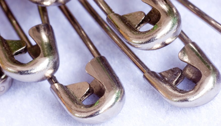 Silver- or gold-plated safety pins make an inexpensive watch band. Silver- or gold-plated safety pins make an inexpensive watch band.