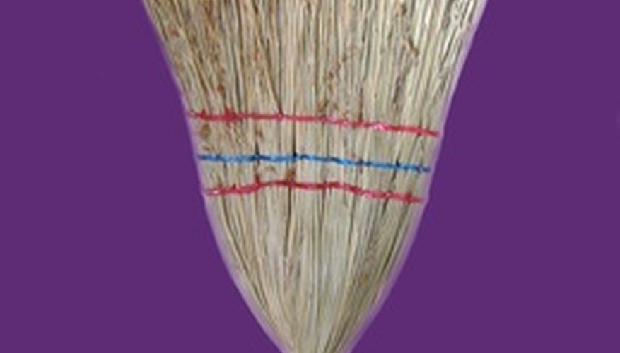 Photo Credit: broom image by L. Shat from <a href='http://www.fotolia.com'>Fotolia.com</a> Brooms and a rolled-up sock are the only items you need for this fun indoor game.