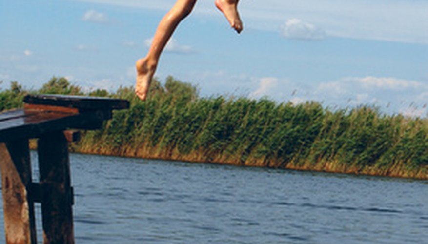 Photo Credit: boy diving into the river image by Cherry-Merry from <a href='http://www.fotolia.com'>Fotolia.com</a> You can use two pieces of string or rope to make the banks of an indoor river.