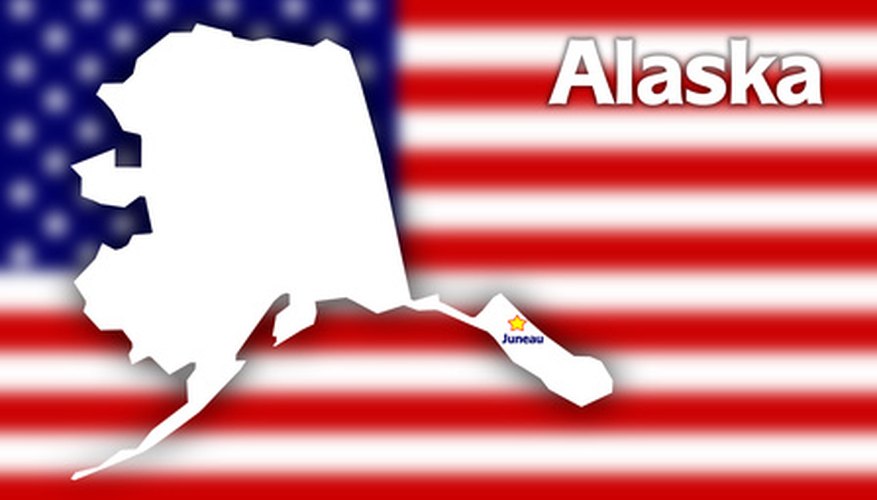 Photo Credit: Alaska state contour with Capital City against blurred USA flag image by Stasys Eidiejus from <a href='http://www.fotolia.com'>Fotolia.com</a> Alaska is home of the Iditarod.