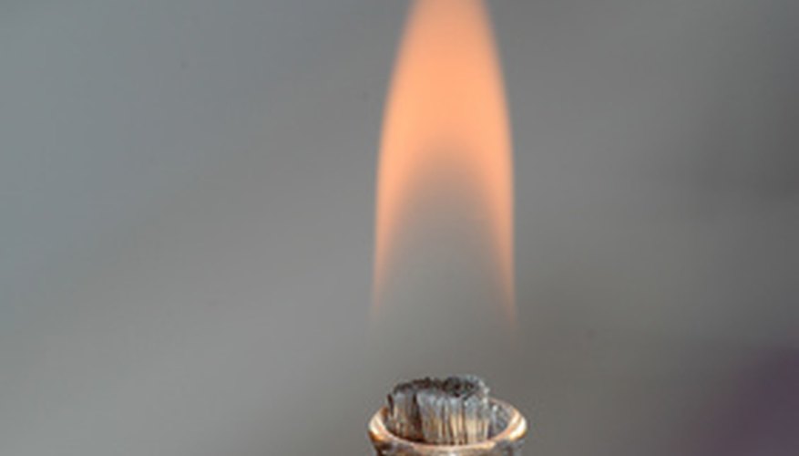 An oil lantern has a kerosene reservoir and a wick submerged in it. An oil lantern has a kerosene reservoir and a wick submerged in it.