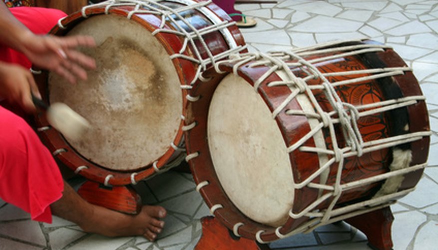 Photo Credit: tahitian drums image by Xavier MARCHANT from <a href='http://www.fotolia.com'>Fotolia.com</a> Tambora drums are played with sticks in Venezuela's gaita music style.