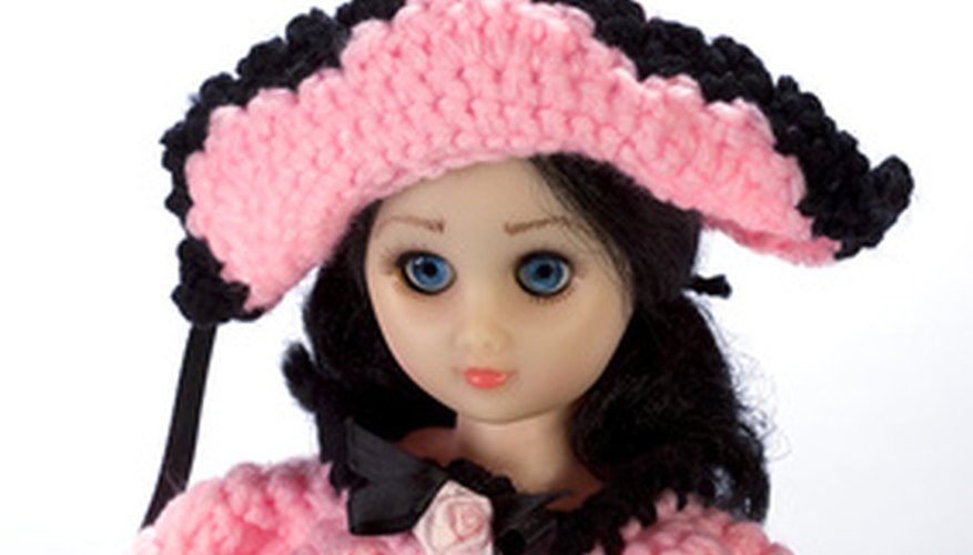 Crocheting a bed doll dress requires intricate stitch details. Crocheting a bed doll dress requires intricate stitch details.