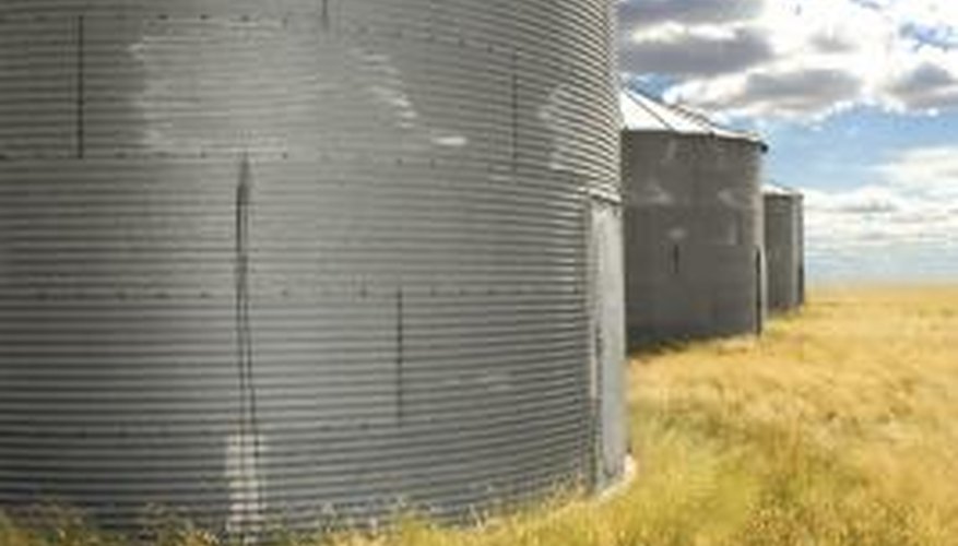 Concrete should extend beyond the grain bin to prevent water from getting inside. Concrete should extend beyond the grain bin to prevent water from getting inside.
