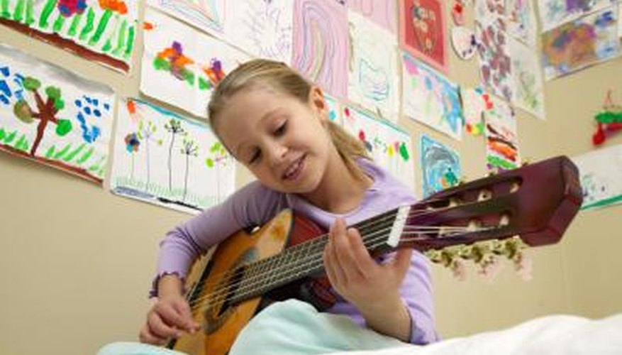 Photo Credit: Ableimages/Digital Vision/Getty Images Little girl playing guitar