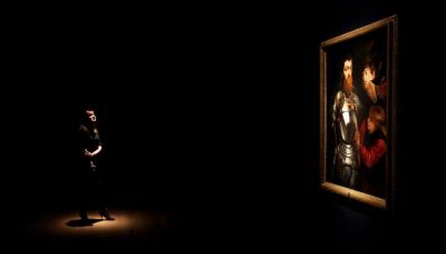 A woman examines a painting by Peter Paul Rubens. A woman examines a painting by Peter Paul Rubens.