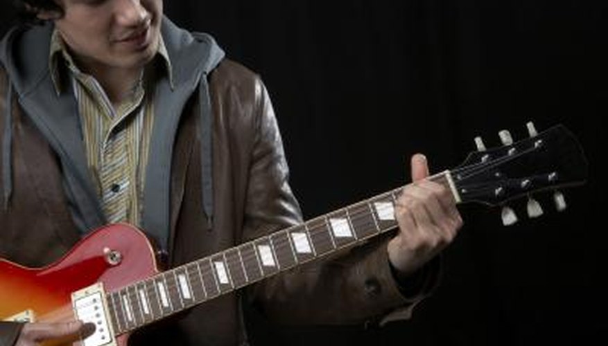 Young man playing electric guitar. Young man playing electric guitar.