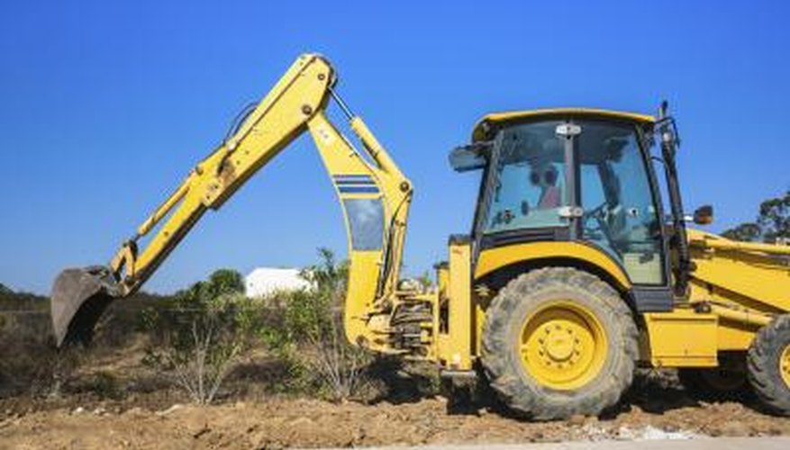 A backhoe can dig a pool hole quickly but needs a lot of space to operate. A backhoe can dig a pool hole quickly but needs a lot of space to operate.