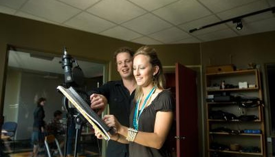 Photo Credit: Jupiterimages/Photos.com/Getty Images Singer in recording studio