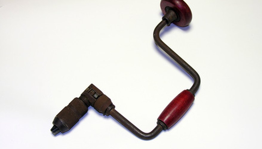 Antique hand drill with wooden crank. Antique hand drill with wooden crank.
