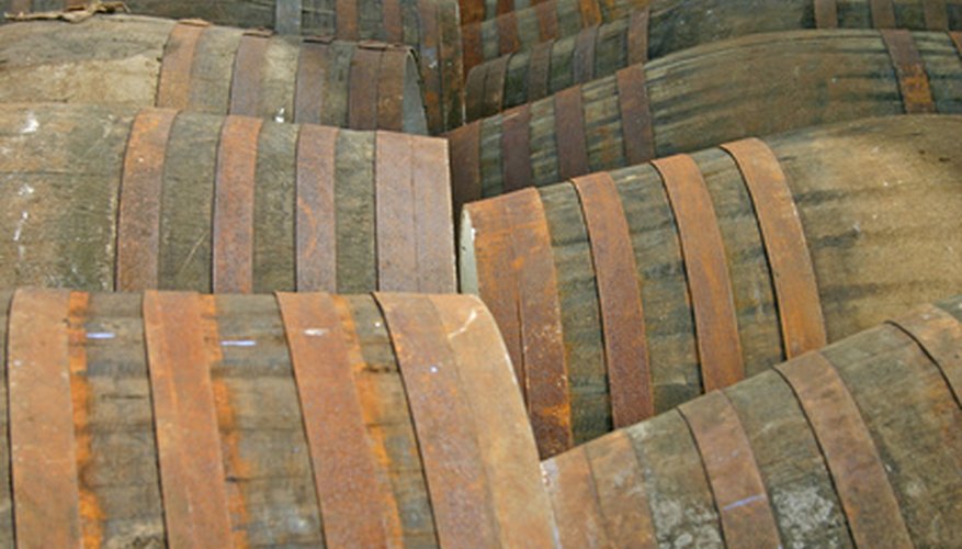 Halved whiskey barrels make heavy-duty, rustic container gardens. Halved whiskey barrels make heavy-duty, rustic container gardens.