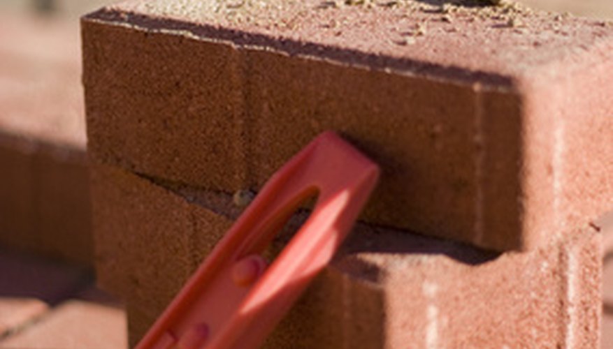 Landscapers effectively use bricks to discourage grass growth on agrden edges. Landscapers effectively use bricks to discourage grass growth on agrden edges.