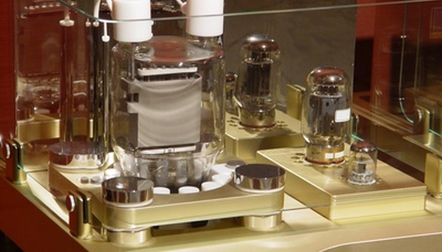 Photo Credit: Amplifier image by Mladenov from <a href='http://www.fotolia.com'>Fotolia.com</a> The power amp in this unit is located below the two white cylinders.