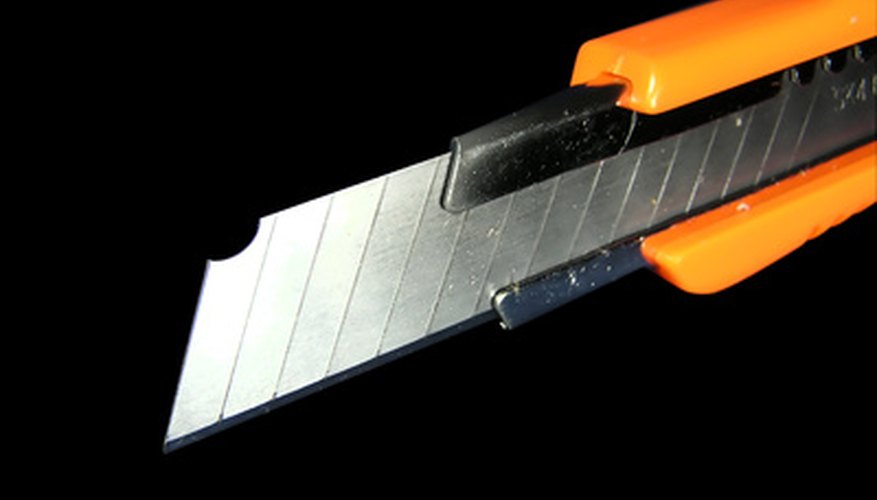 Photo Credit: knife image by Andrey Khritin from <a href='http://www.fotolia.com'>Fotolia.com</a> A retractable blade works well for theatrical stabbings.