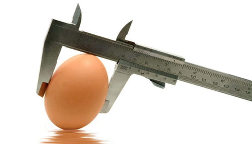Photo Credit: caliper measuring the egg image by JoLin from <a href='http://www.fotolia.com'>Fotolia.com</a> Marbles can be measured with a caliper