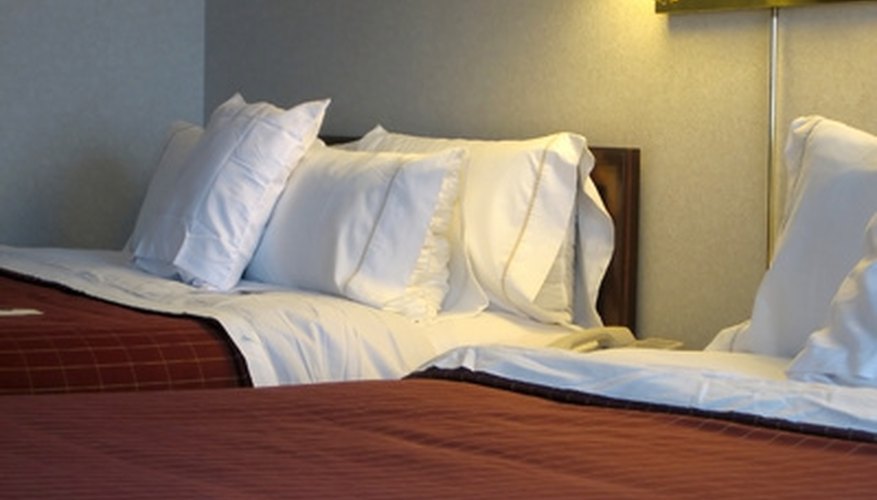 Two beds made up with linens. Two beds made up with linens.