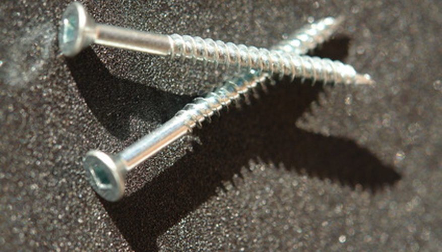 Photo Credit: screws image by Horticulture from <a href='http://www.fotolia.com'>Fotolia.com</a> Most bicycles come with two pre-drilled screws ready to attach a water bottle holder.