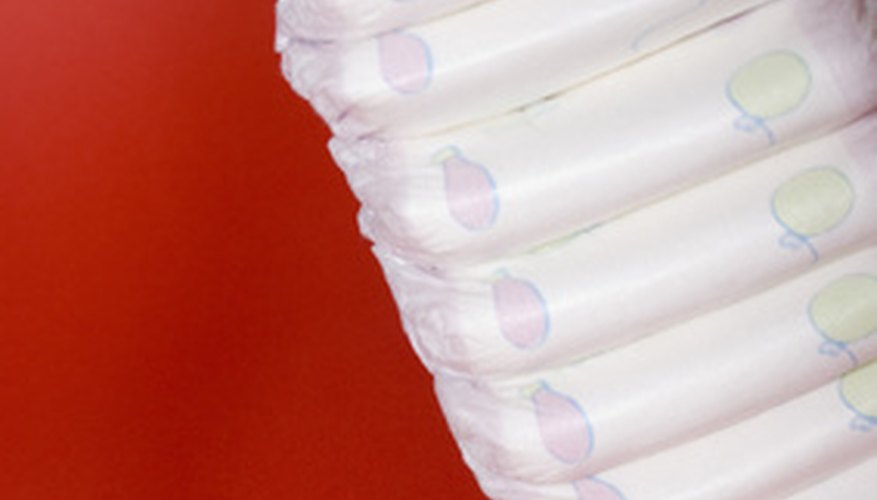Roll diapers to assemble a cake that resembles a castle. Roll diapers to assemble a cake that resembles a castle.