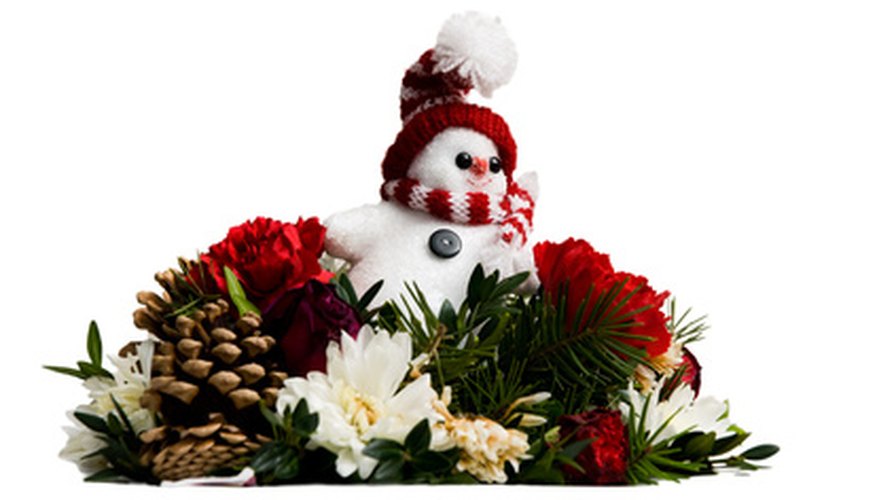 A Christmas floral arrangement is pleasing to children and adults. A Christmas floral arrangement is pleasing to children and adults.