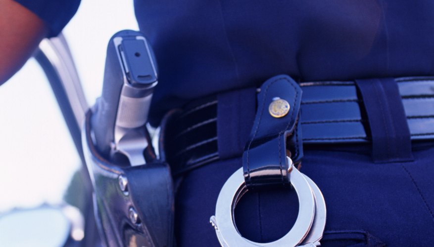 Police officers use belly chains with handcuffs to restrain prisoners. Police officers use belly chains with handcuffs to restrain prisoners.