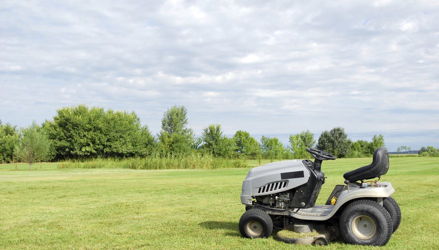 Lawn tractor parked in front of an open field Lawn tractor parked in front of an open field