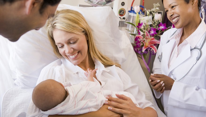 Mother holding newborn baby in hospital Mother holding newborn baby in hospital