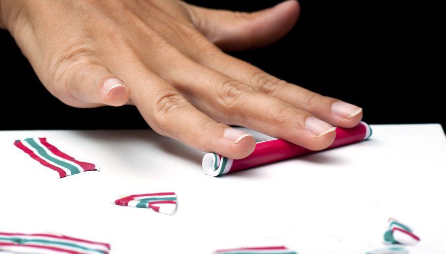 Use your hands or a pasta maker to soften polymer clay. Use your hands or a pasta maker to soften polymer clay.