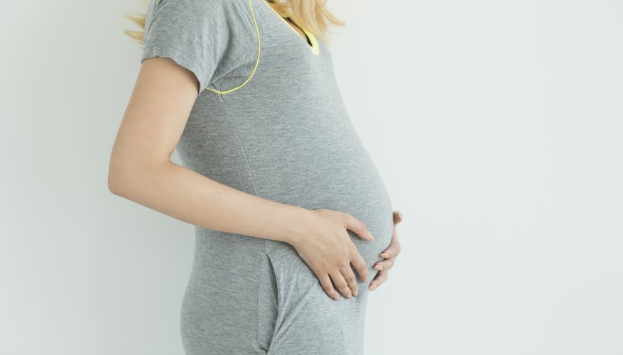 Pregnant woman with hands on stomach. Pregnant woman with hands on stomach.