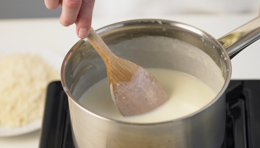 Mixing a pan of cream on the stove. Mixing a pan of cream on the stove.