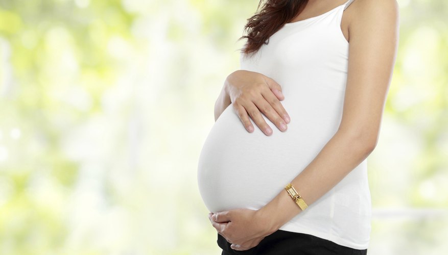 Pregnant woman holding her stomach. Pregnant woman holding her stomach.
