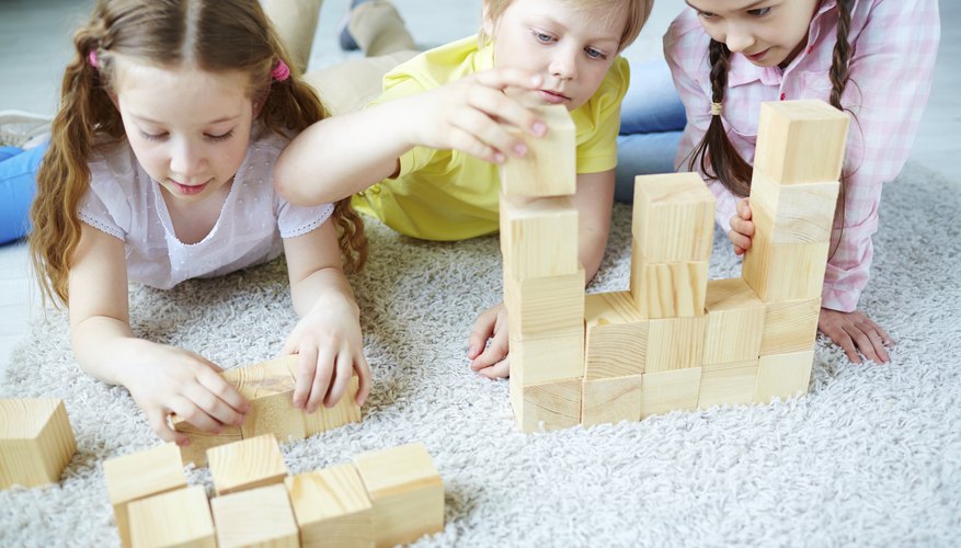 Children play with wooden blocks Children play with wooden blocks