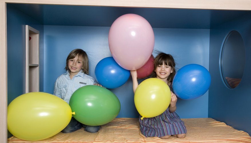 A boy and girl playing with balloons. A boy and girl playing with balloons.
