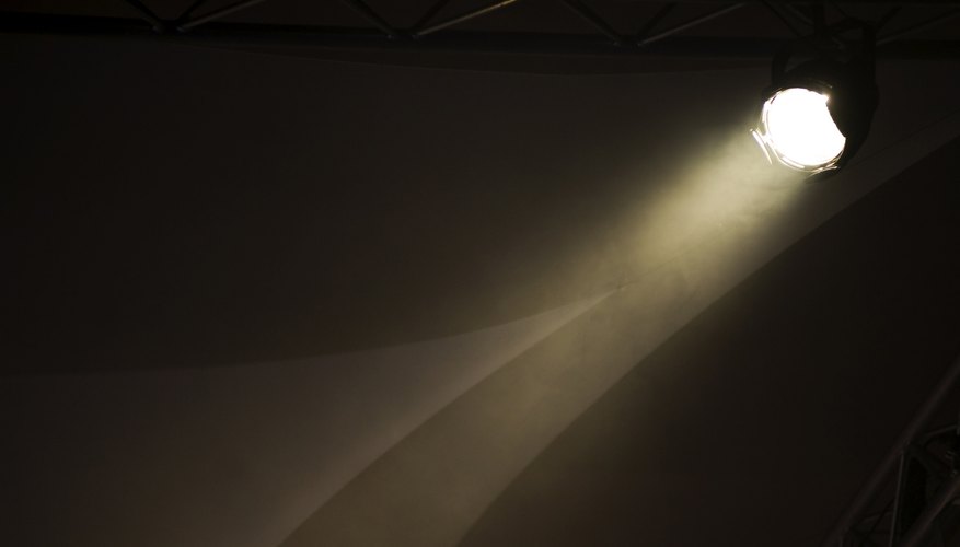 A beam from a spotlight shines down into the darkness. A beam from a spotlight shines down into the darkness.