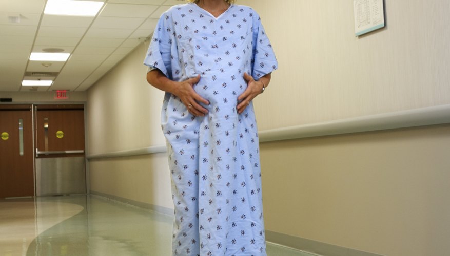 Pregnant woman walking in hospital Pregnant woman walking in hospital