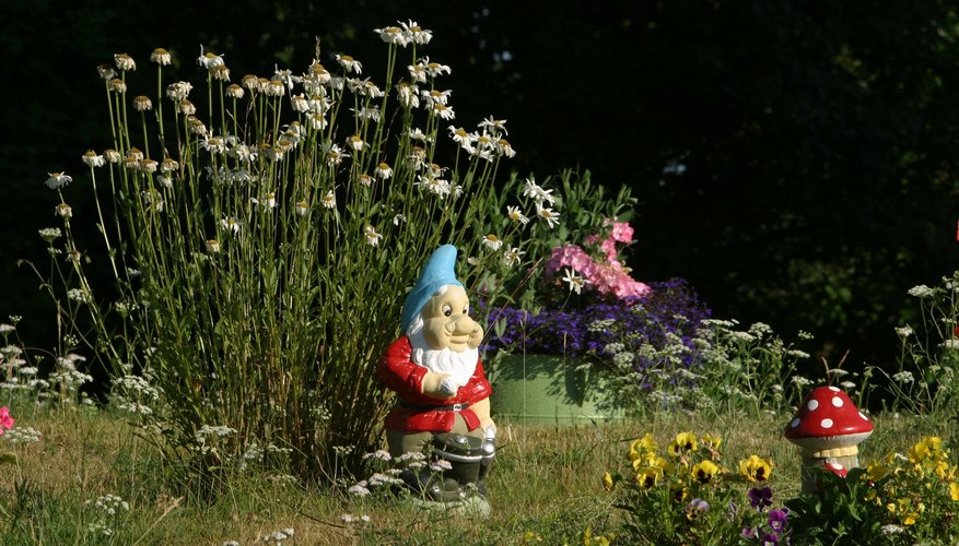Attach a decorative gnome door to a large rock or garden structure. Attach a decorative gnome door to a large rock or garden structure.