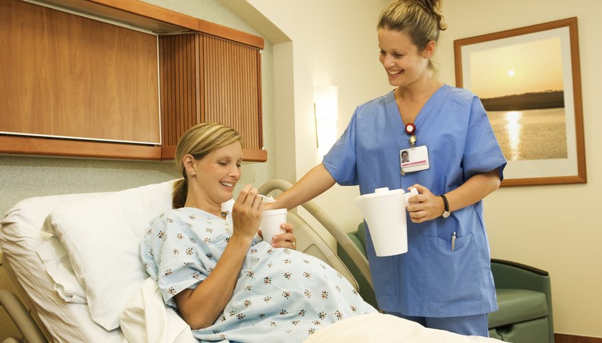 Pregnant woman in hospital, drinking water Pregnant woman in hospital, drinking water